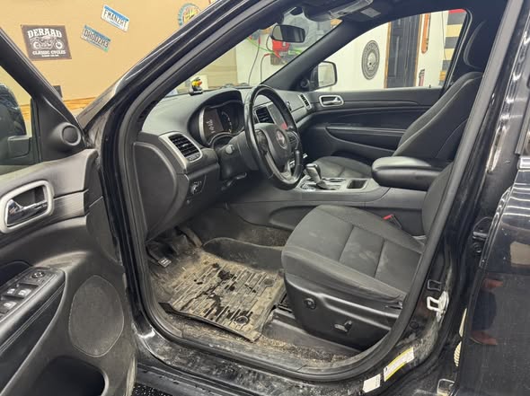 Work vehicle interior before detailing, covered in mud and debris